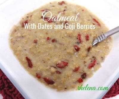 A bowl of cooked oatmeal with goji berries.