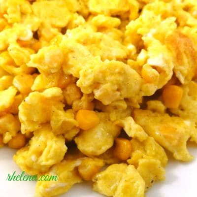 A closeup of scrambled eggs and corn.