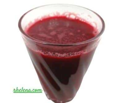 Apple, Beet and Carrot Juice shown in a glass.