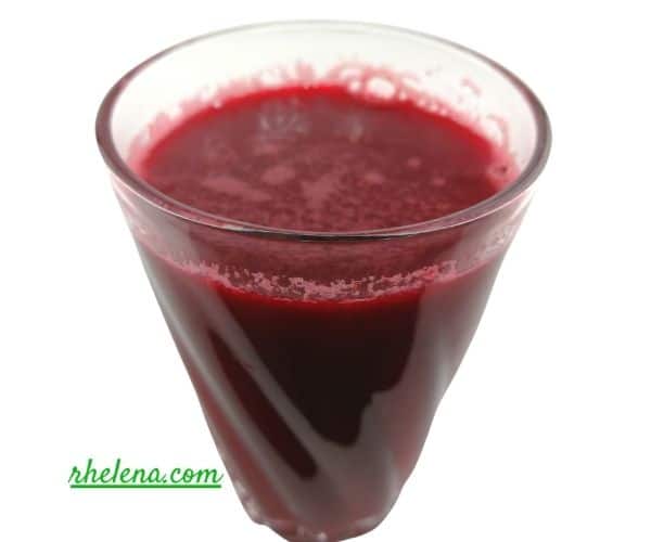 Apple, Beet and Carrot Juice shown in a glass.