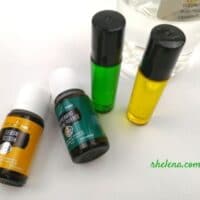 Two roller bottles shown with peppermint essential oil and lemon essential oil.