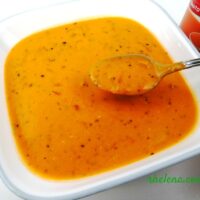 A bowl of creamy tomato soup from a can, dressed up with Italian herbs.