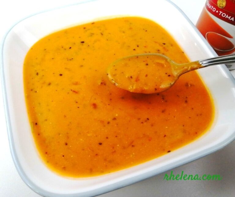 A bowl of creamy tomato soup from a can, dressed up with Italian herbs.