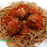 Meatballs shown on einkown spaghetti.