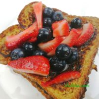 French toast shown with blueberries and strawberries.