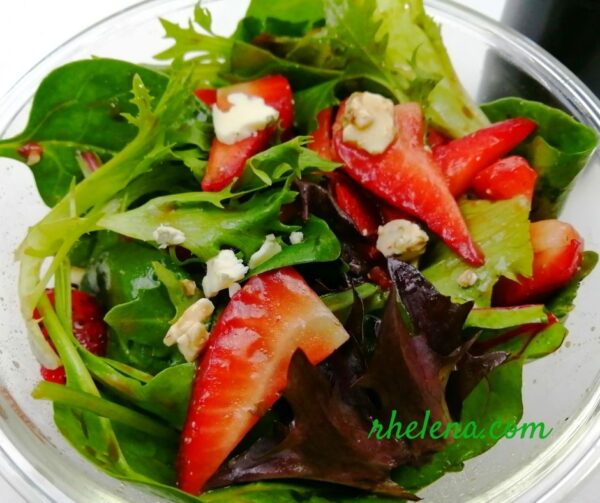 Salad with mixed greens and strawberries.