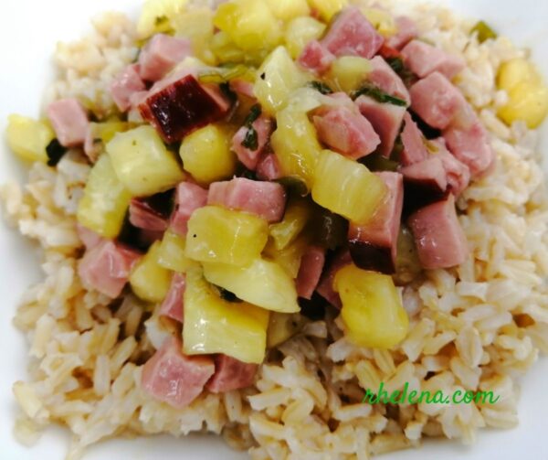Ham and pineapple served over a bowl of rice.