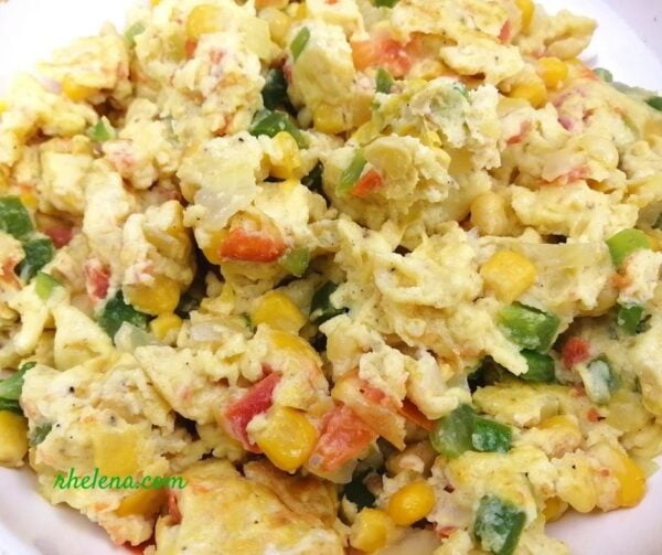 Scrambled eggs with corn, bell peppers and tomato.